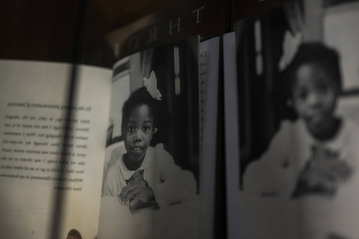 A photograph of Ruby Bridges as a little girl is reflected in a mirror, taken from an autobiography.
